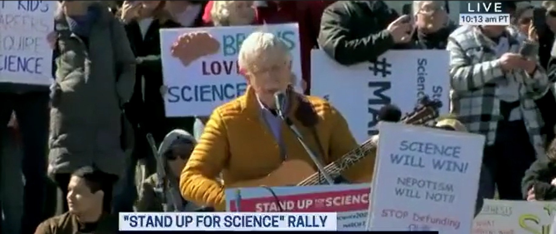 At Anti-Trump Rally, Former NIH Director Sings The Same Way He Practices Science