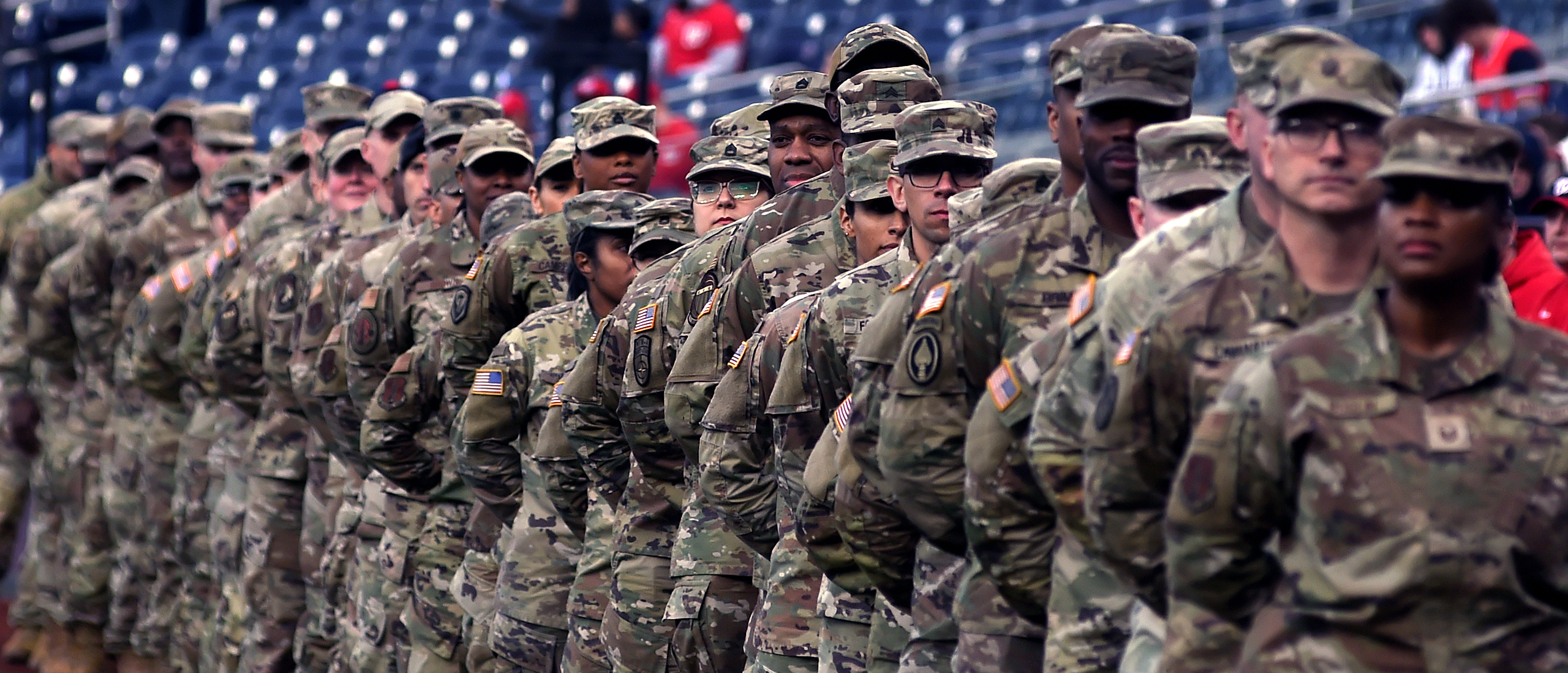 National Guard Soldiers and Airmen stand on the sidelines during pre-game festivities as part of the Washington Nationals’ match-up against the Philadelphia Phillies at Nationals Park stadium in Washington, D.C., April 5, 2024. National Guard Soldiers and Airmen took part in pre-game activities as part of the park’s National Guard Night, which highlighted the Guard’s mission as the combat arms reserve of the Army and Air Force and its role in responding during emergencies at home. (Wikimedia Commons/Public/The National Guard/Sgt. 1st Class Jon Soucy)