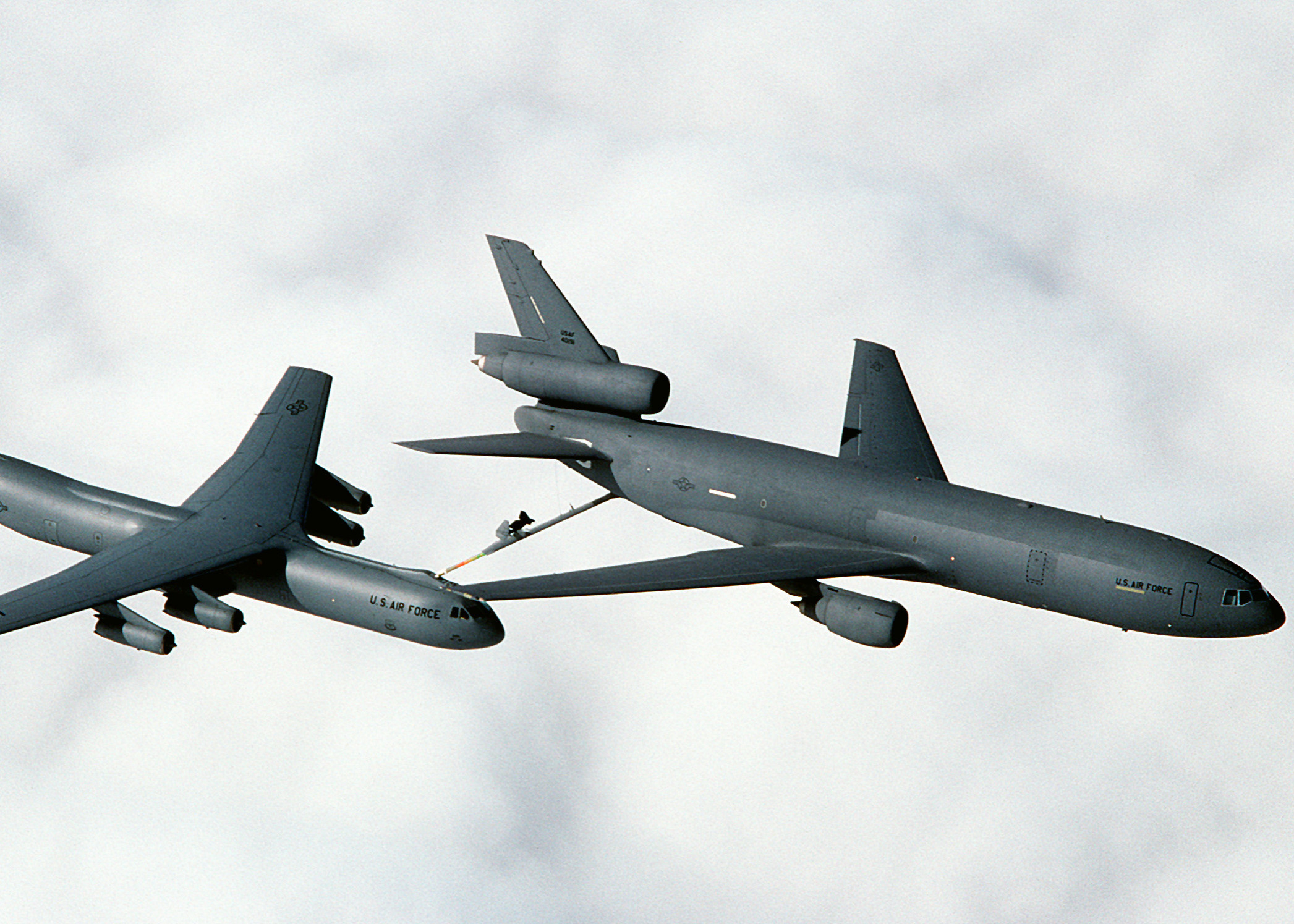 A 79th Air Refueling Squadron (79th AREFS) KC-10A Extender aircraft refuels a 7th Airlift Squadron (7th AS) C-141B Starlifter aircraft as the two planes fly above the clouds over northern California. The KC-10 Extender is an air-to-air tanker aircraft in service with the United States Air Force derived from the civilian DC-10-30 airliner. The KC-10 was the second consecutive McDonnell Douglas transport aircraft to be selected by the US Air Force following the C-9 Nightingale. Conversion to the KC-10 involved only minor modifications to the DC-10-30, the largest of which was the addition of a boom control station in the rear of the fuselage and extra fuel tanks under the main deck. First deliveries to the Strategic Air Command (then in control of AAR assets) commenced in 1981. The USAF Strategic Air Command had KC-10 Extenders in service from 1981 through 1991, when they were re-assigned to the Air Mobility Command. [U.S. Air Force Photo by Staff Sgt. John McDowell]