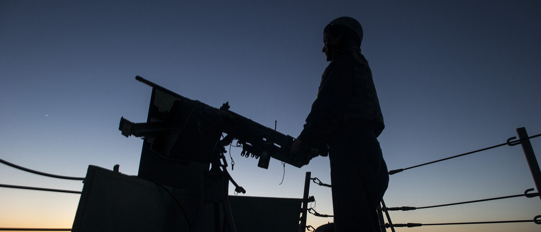 U.S. Navy Yeoman 3rd Class Megan Ludwig mans a .50-caliber machine gun aboard the guided missile destroyer USS Truxtun (DDG 103) as the ship transits the Strait of Hormuz June 14, 2014. The Truxtun was part of the George H.W. Bush Carrier Strike Group and was underway in the U.S. 5th Fleet area of responsibility supporting maritime security operations and theater security cooperation efforts. (DoD photo by Mass Communication Specialist 3rd Class Scott Barnes, U.S. Navy/Released)